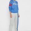 Pantaloni de sport Ralph Lauren cu dungi laterale de damă bej Pantaloni de sport Ralph Lauren cu dungi laterale de damă bej